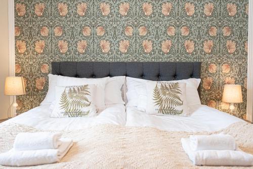 a bedroom with a large bed with white sheets and pillows at Tokeryds Herrgård in Jönköping