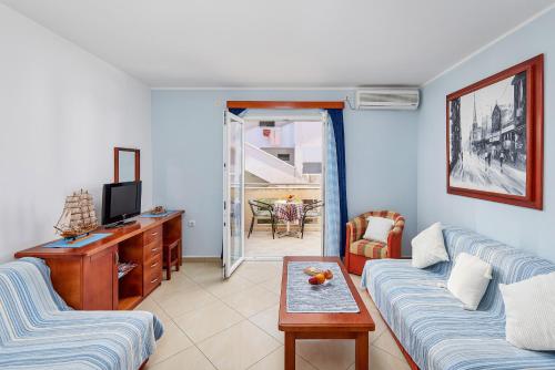 a living room with a couch and a tv at Rosic Apartments Tivat in Tivat