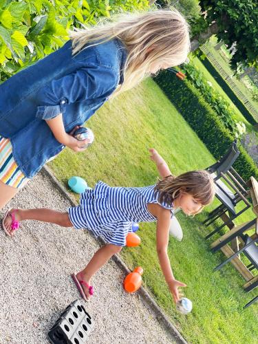 a little girl playing with plastic balls in the grass at Hotel het Elsland in Wervik