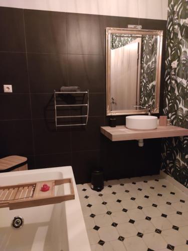 a bathroom with a sink and a mirror and a tub at Apartments Sabo in Kraljevica