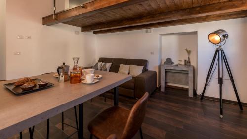 a living room with a table and a couch at SUITE 39 in Molfetta