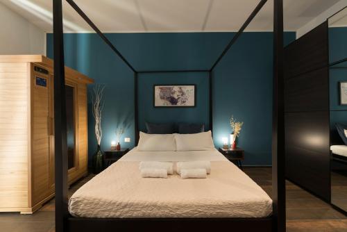 a bedroom with a canopy bed with two pillows at SUITE 39 in Molfetta