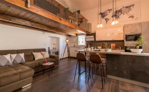 a living room and kitchen with a couch and a bar at SUITE 39 in Molfetta