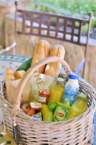 a basket filled with bread and food on a table at Terre d'Orizon in Tourrettes-sur-Loup