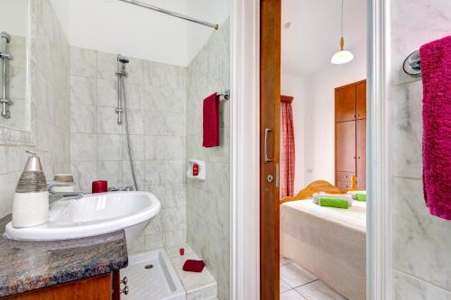 a bathroom with a sink and a shower at Villa Pandora by Villa Plus in Peyia