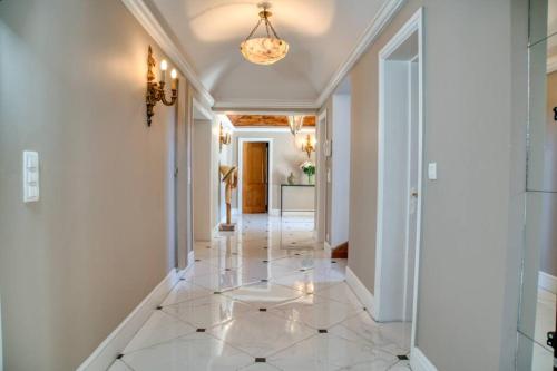 a hallway with a tile floor and a chandelier at BASTIDE PROVENÇALE PROCHE CANNES in Peymeinade