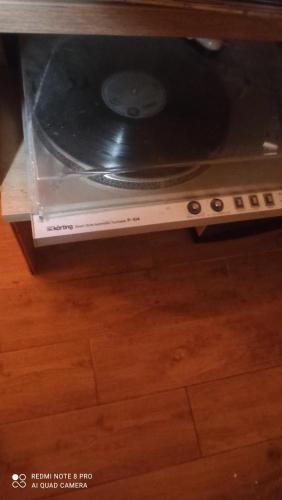 a record player with a cd in a drawer at Green House in Rijeka