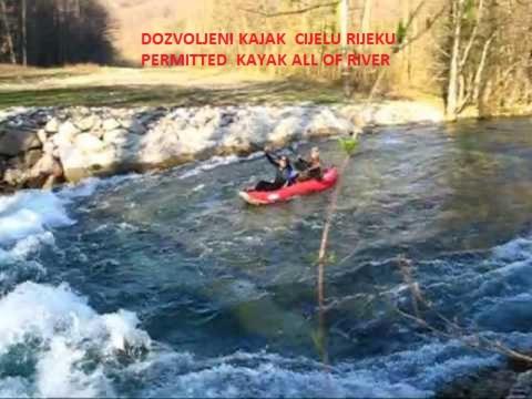 two people in a red kayak in a river at Green House in Rijeka