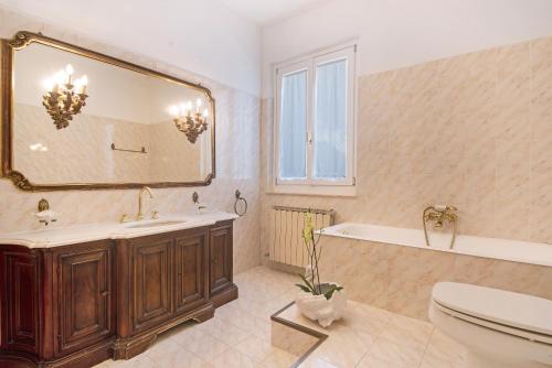 a bathroom with a tub and a sink and a mirror at Miriam e Carlo in Moneglia