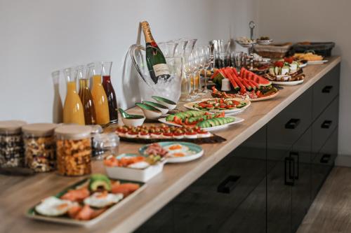 a buffet with plates of food and bottles of wine at Hotel Waldeslust in Kurort Altenberg