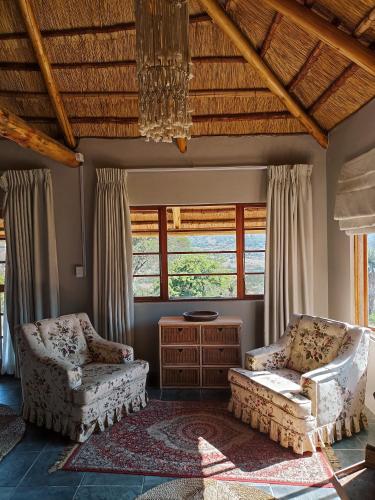 a living room with two chairs and a couch at Harmony Game Lodge in Middlerus