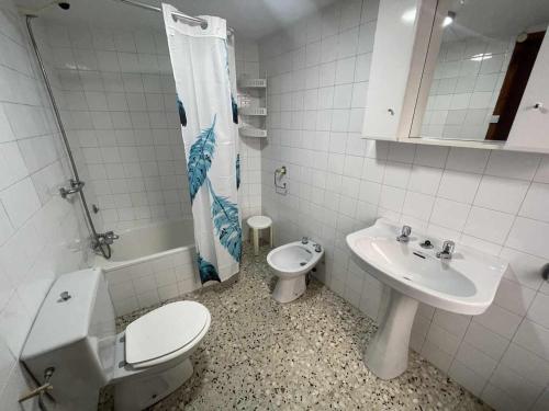 a bathroom with a toilet and a sink at Grupo Gontad Casa Baixo da Capilla Corme in A Coruña