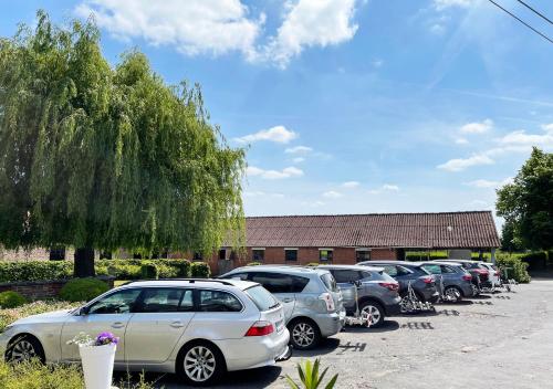 a row of cars parked in a parking lot at Hotel het Elsland in Wervik