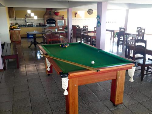 a pool table with a ball on top of it at Pousada Pena in Mucuri