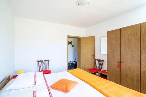 a bedroom with a bed and some wooden cabinets at Apartment Laurel Leaf in Lovorno