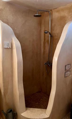 a shower with two urinals in a bathroom at Casa Bianca of Kea in Melissaki