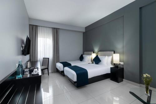 a hotel room with a bed and a desk at MaRadha Colombo in Colombo