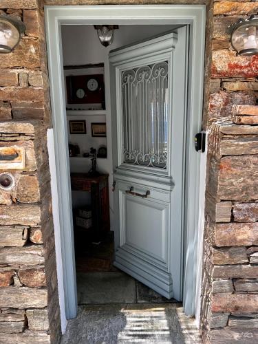 a door leading into a room with a brick wall at Casa Bianca of Kea in Melissaki