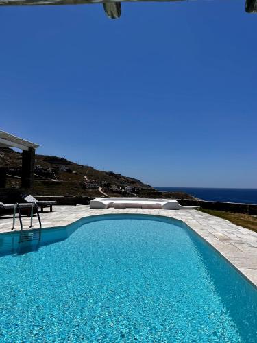 a swimming pool with a view of the ocean at Casa Bianca of Kea in Melissaki
