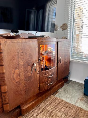 a large wooden cabinet in a room with a window at Casa Bianca of Kea in Melissaki