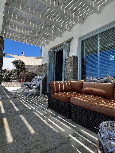 a couch sitting on the patio of a house at Casa Bianca of Kea in Melissaki