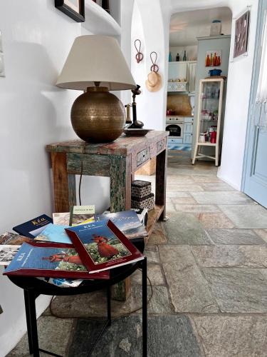 a room with a table with a lamp on it at Casa Bianca of Kea in Melissaki