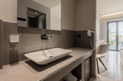 a bathroom with a sink on a counter at Zante Sun Resort in Lithakia