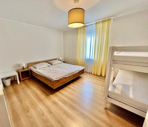 a bedroom with a bed and a bunk bed at HOP HOUSE Garni Hotel in Postojna