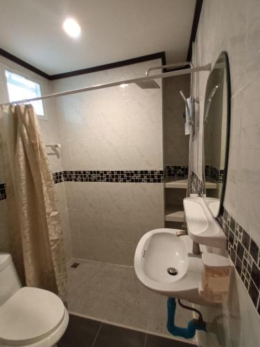 a bathroom with a toilet and a sink and a shower at Cana Boutique Hotel in Bangkok