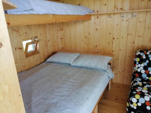 a bedroom with a bed in a wooden cabin at Glamping with a view in Smlednik