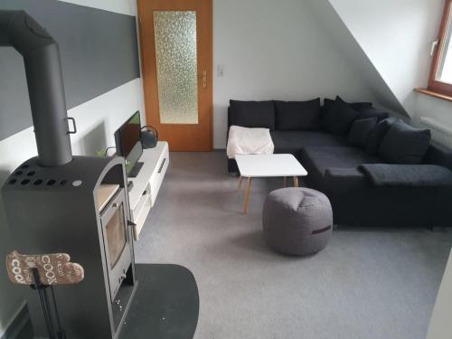 a living room with a couch and a stove at Ferienwohnung Brendle in Sankt Johann