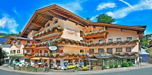 a building with flowers on the side of it at Hotel Wagrainerhof in Wagrain