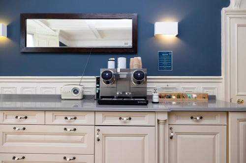 a counter with a coffee maker on top of it at JOIVY Haymarket in Edinburgh