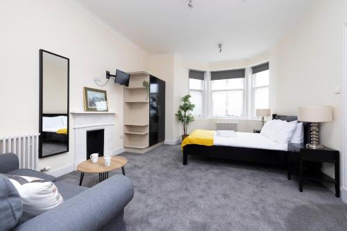 a living room with a bed and a fireplace at JOIVY Haymarket in Edinburgh