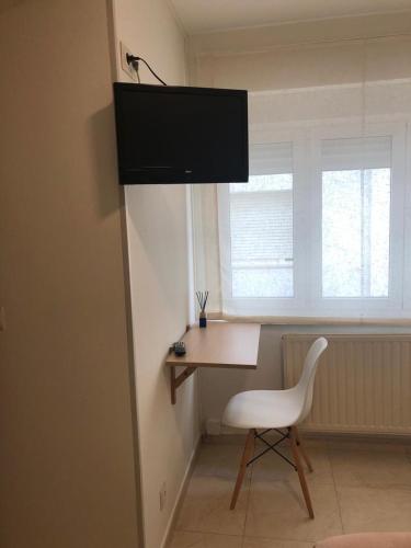 a desk and a chair in a room with a window at Pensión Cantabrico in Navia