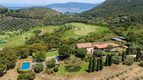 an aerial view of a mansion with a golf course at Country Relais La Mortella in Porto Ercole