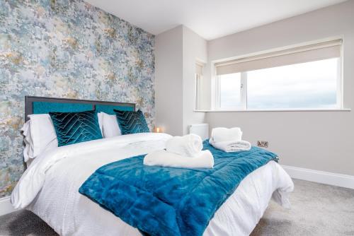 a bedroom with a large bed with towels on it at Morningside Hotel in Whitby