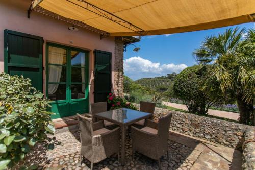 a table and chairs on the patio of a house at Country Relais La Mortella in Porto Ercole
