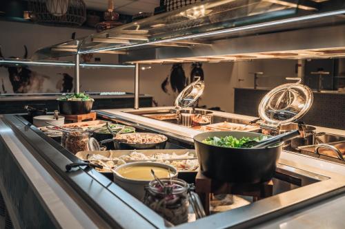 a kitchen with many dishes of food at Belambra Clubs Port Camargue - Les Salins in Le Grau-du-Roi