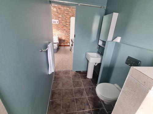 a bathroom with a toilet and a sink at The Beach Hide in East London