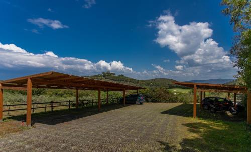 a pavilion with a car parked in a field at Country Relais La Mortella in Porto Ercole
