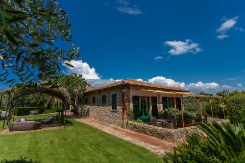 a stone house with a garden in front of it at Country Relais La Mortella in Porto Ercole