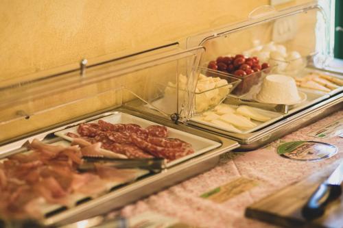 a buffet with meats and cheese and other foods at Country Relais La Mortella in Porto Ercole