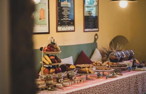 a table with a display of fruit and other foods at Country Relais La Mortella in Porto Ercole