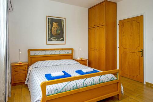 a bedroom with a bed with blue pillows on it at Villa Galazio by Villa Plus in Argaka