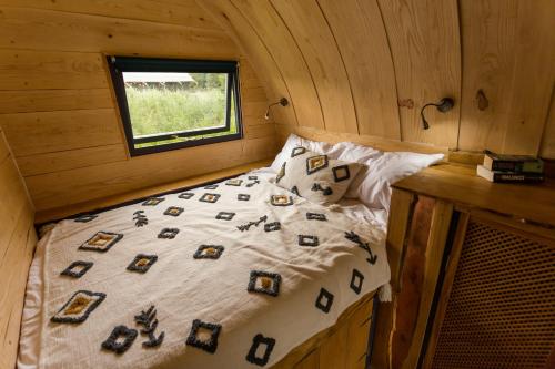 a bedroom with a bed in a cabin with a window at Beautiful 1 bed Glamping pod in Battle in Battle
