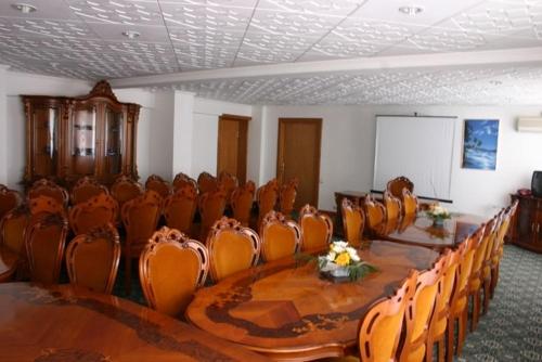 a conference room with a long table and chairs at Hotel Decebal in Bacău