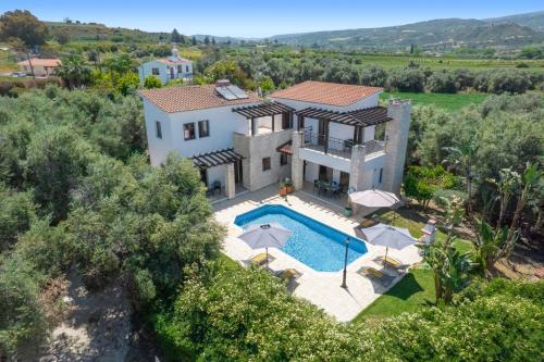 an aerial view of a villa with a swimming pool at Villa Lena by Villa Plus in Prodhromi