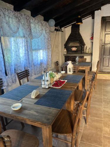 a dining room with a long table and a stove at VILA MILICA & SPA ALEKSANDRA in Dimitrovgrad