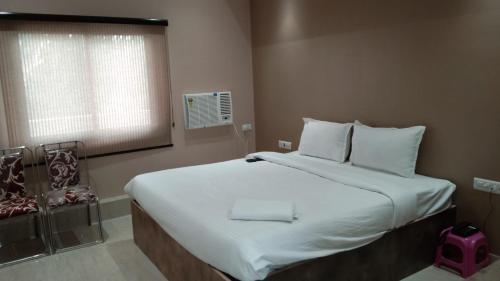 Postel nebo postele na pokoji v ubytování Hotel Sukhdham